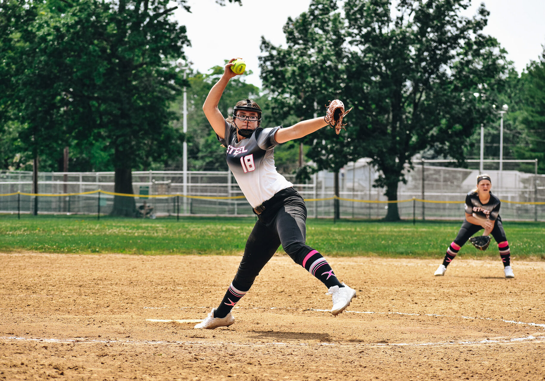 Team Steel softball pitcher mid-pitch